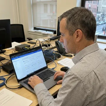 IT specialist managing Google Cloud services on a laptop