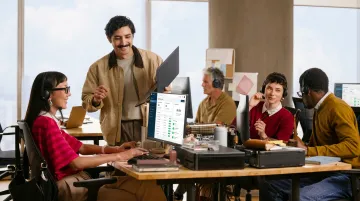 SME sales team using cloud-based call center software on desktop computers in office