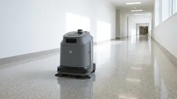 Commercial robotic floor cleaner operating autonomously in modern hospital corridor
