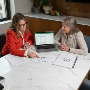 Woman entrepreneur reviewing a business strategy plan with a coach
