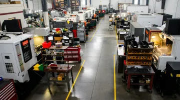 CNC machine shop floor showing lean manufacturing and preventive maintenance practices