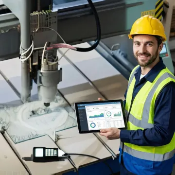 Industrial machinery manufacturer using tablet to view real-time ERP data on shop floor