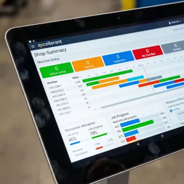 Digital dashboard showing real-time production scheduling and machine status visualization