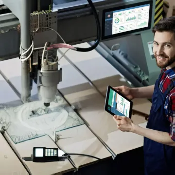 Manufacturing operator using tablet to track job progress on shop floor