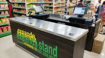 Custom fabricated POS billing counter with integrated cable management and branding panels