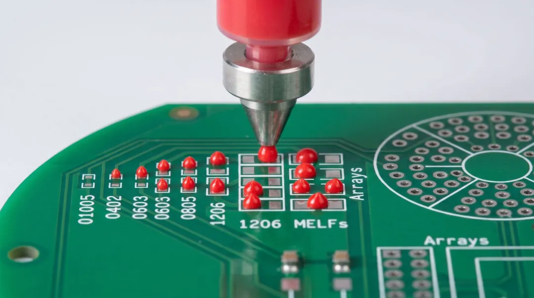 Red glue epoxy adhesive dispensing onto PCB pads before component placement