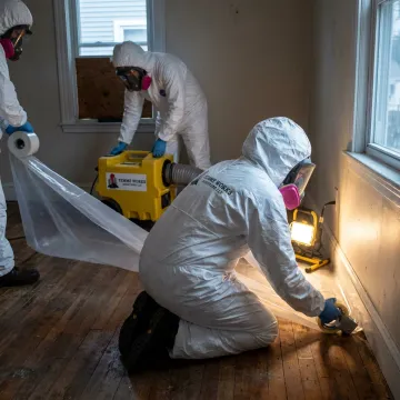 Technicians setting up mold containment barriers