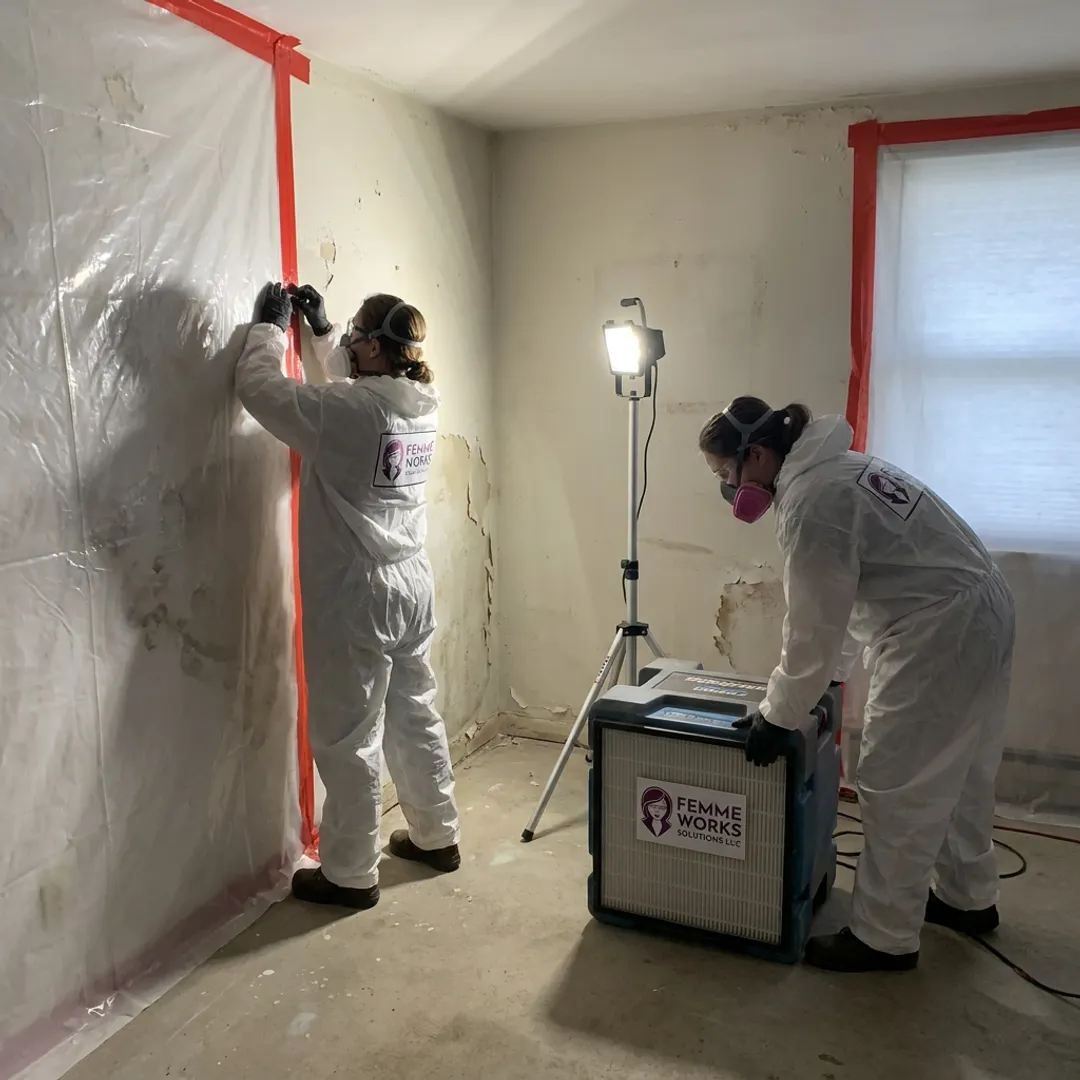 Mold remediation crew setting containment