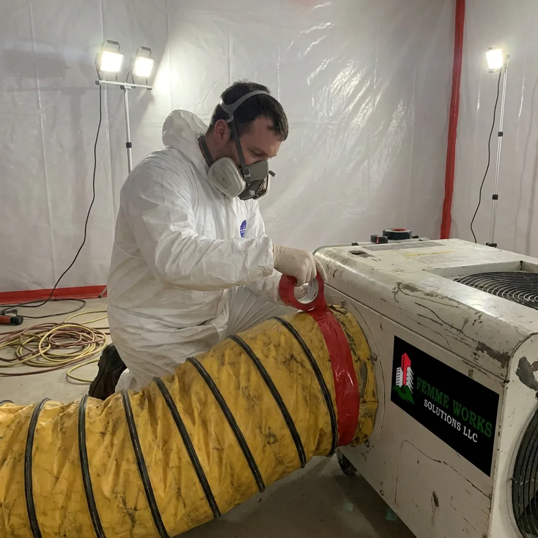 Remediation technician sealing a containment area