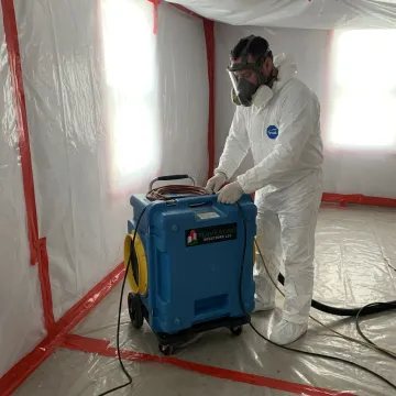 Mold remediation specialist setting containment barriers