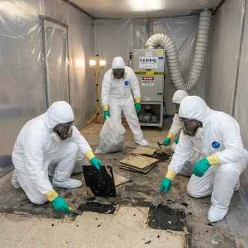 Certified crew removing asbestos floor tile