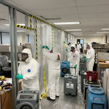 Commercial asbestos removal team in protective gear