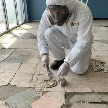 Certified asbestos inspector collecting a material sample