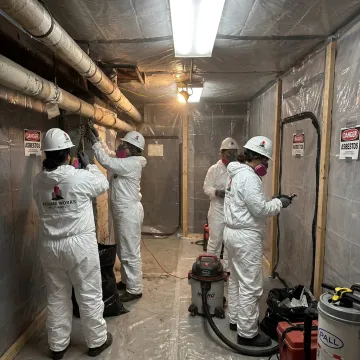 Certified asbestos removal crew in protective gear