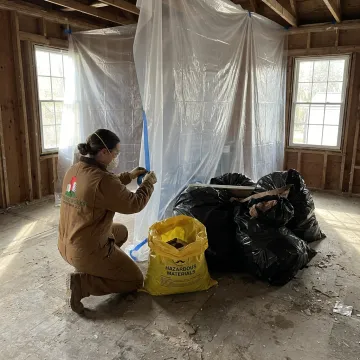 Worker preparing contained demolition area