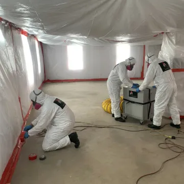 Mold remediation crew setting up containment