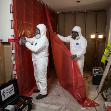 Certified hazardous material abatement crew in protective gear