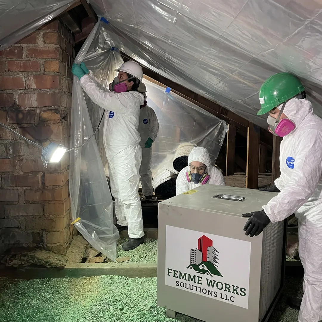 Vermiculite removal crew setting attic containment