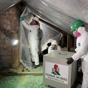 Vermiculite removal crew setting attic containment