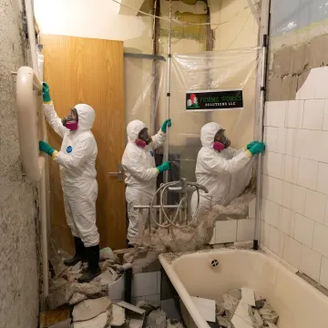 Hazardous materials abatement crew preparing a contained demolition area