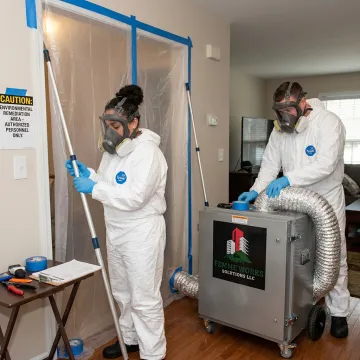 Mold remediation team setting up containment and filtration equipment