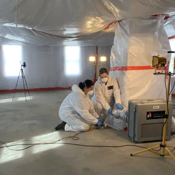 Mold remediation crew setting up containment