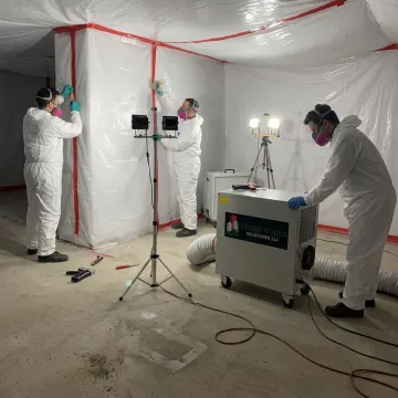 Decontamination crew setting containment barriers