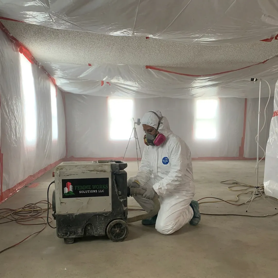 Technician preparing containment for ceiling abatement