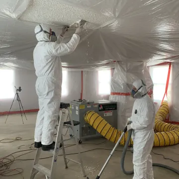 Asbestos popcorn ceiling removal in a contained room