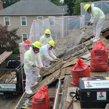 Certified crew removing asbestos roofing materials