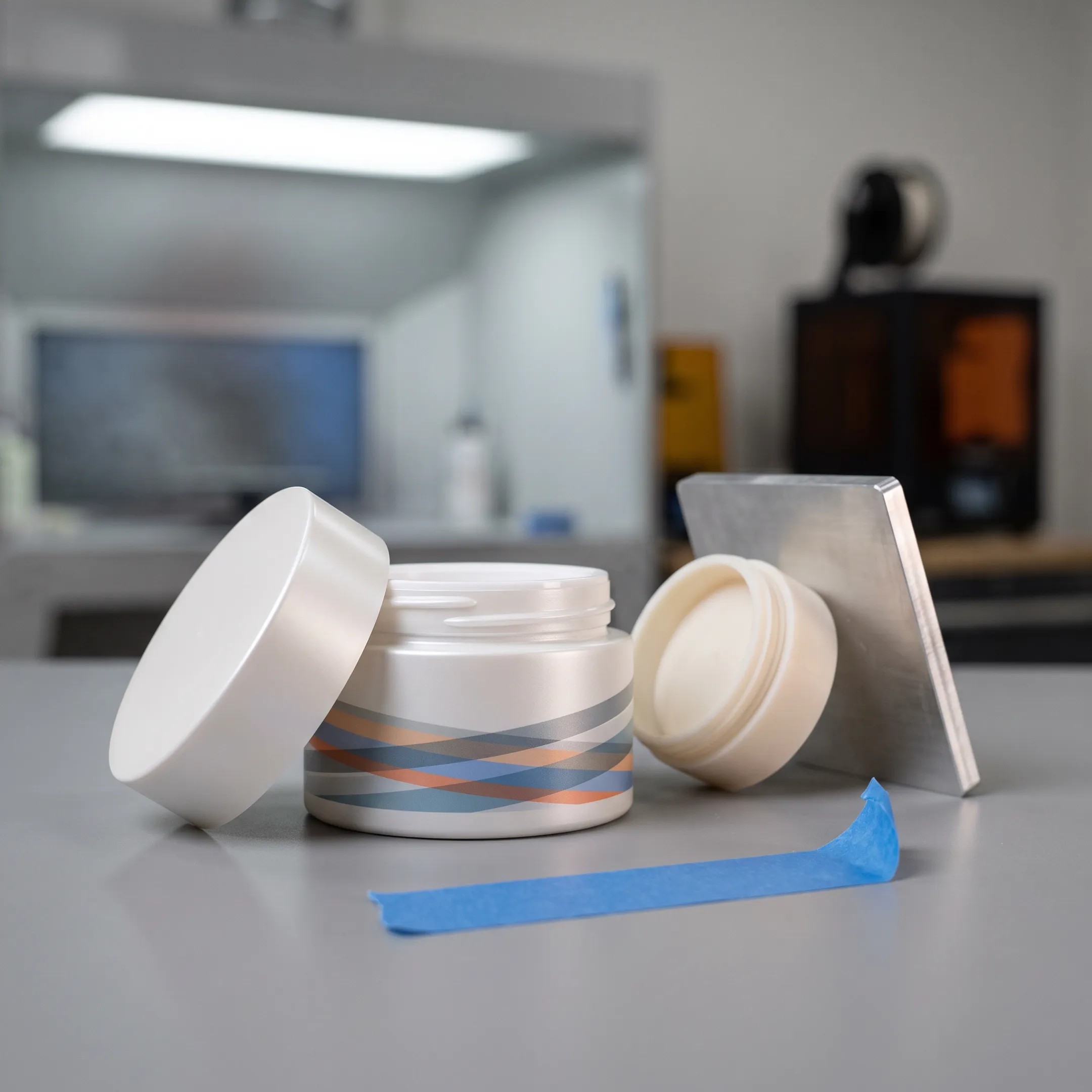 Finished cosmetic packaging prototype with custom graphics and painted surfaces