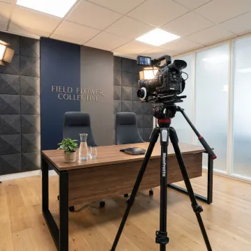 Modern video conference room with professional lighting and branded background