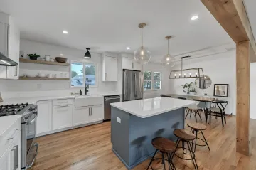 Designer consulting with homeowner over fabric swatches and design boards