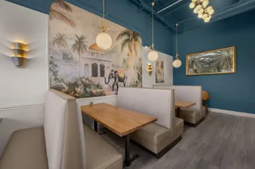 Designer reviewing fabric swatches and color palettes with homeowner during consultation