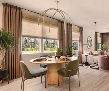 Interior designer consulting with Houston homeowner showing fabric samples and design boards