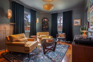 Interior designer reviewing renovation plans and material samples with homeowners