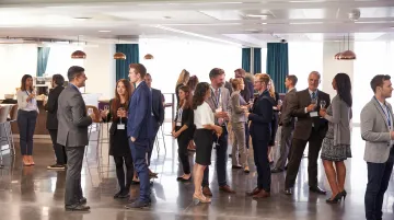 Professional networking event with MedTech industry professionals exchanging business cards and connecting