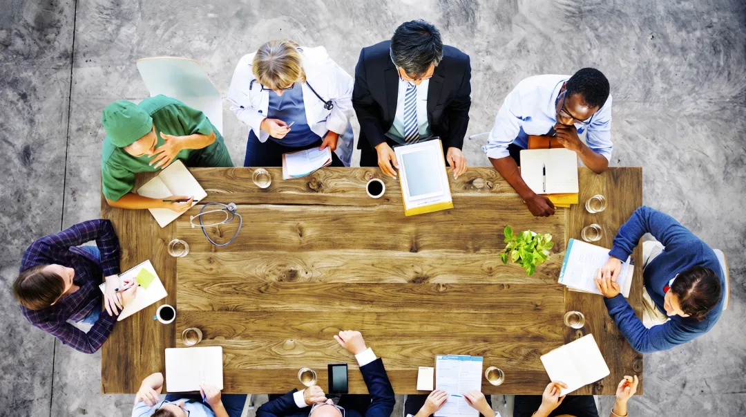Diverse professional team collaborating in modern MedTech or healthcare technology office environment