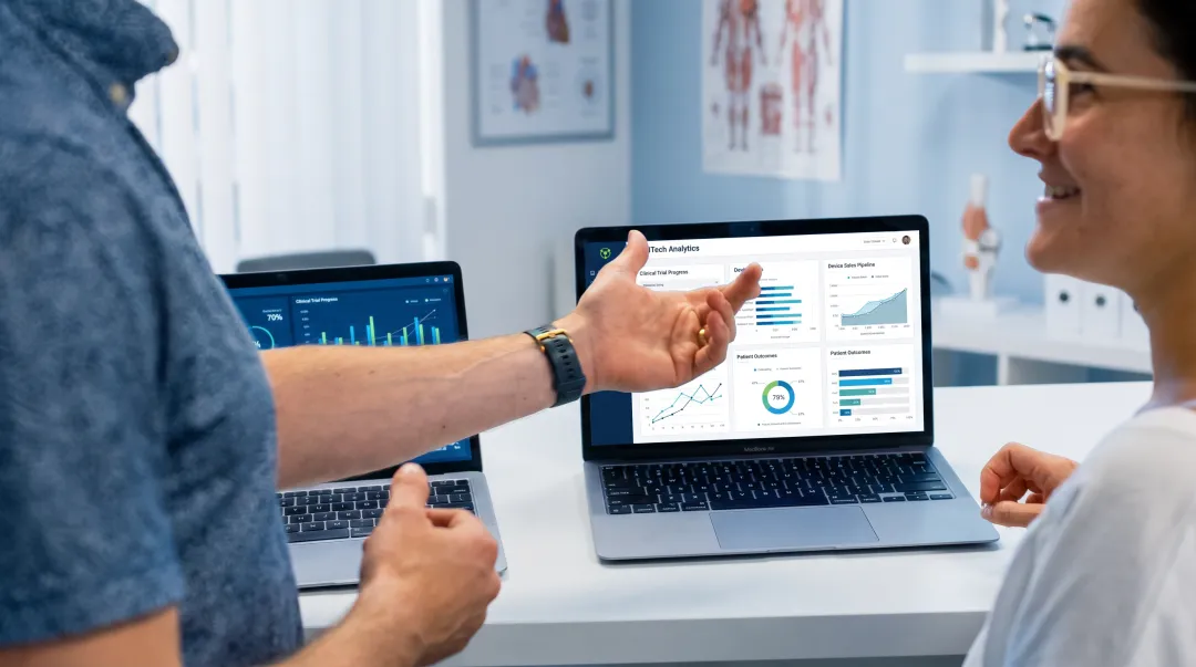 Medical device sales manager conducting coaching session with sales representative reviewing clinical data