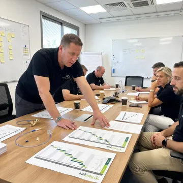 MedTech project manager leading a team meeting