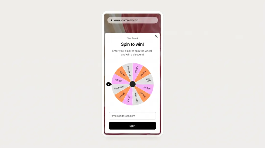 Gamified spin-to-win wheel popup interface on mobile device screen