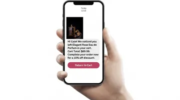 Mobile phone showing personalized abandoned cart MMS with product image and recovery offer