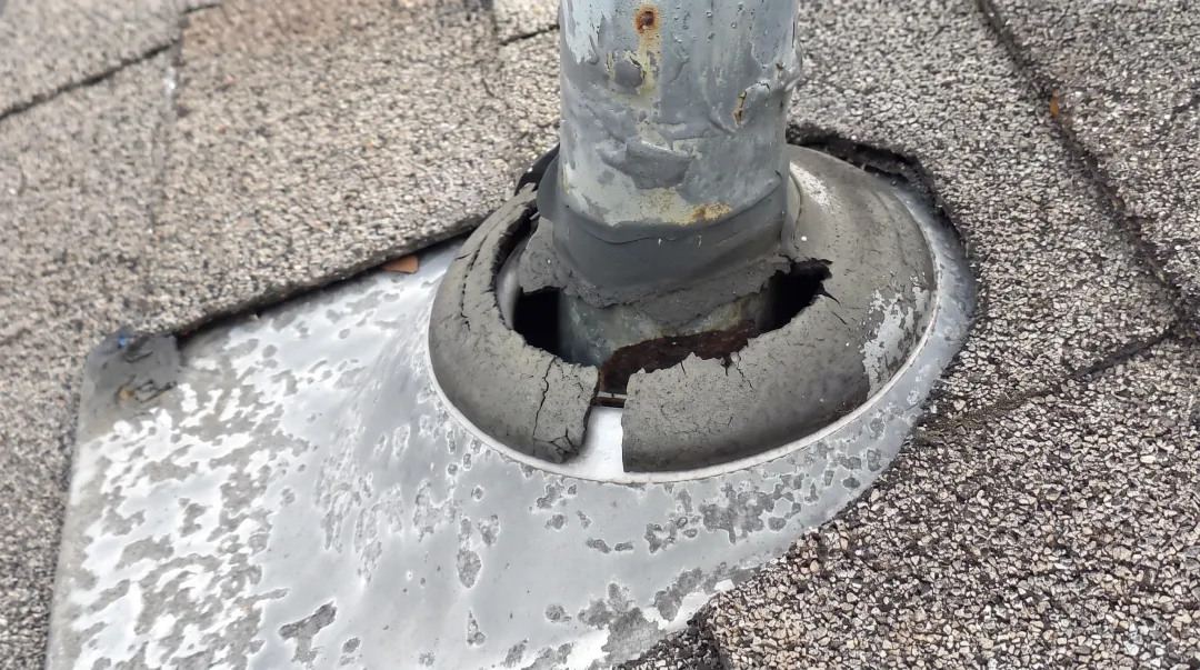 Cracked rubber roof vent pipe boot showing UV weathering damage