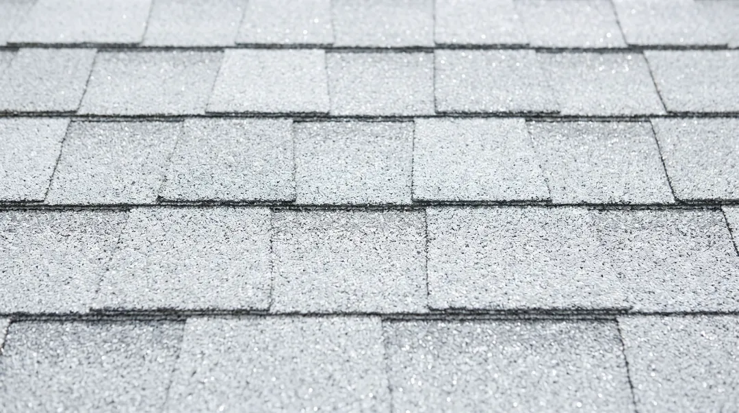 Cool-rated asphalt shingles with reflective granules on residential roof