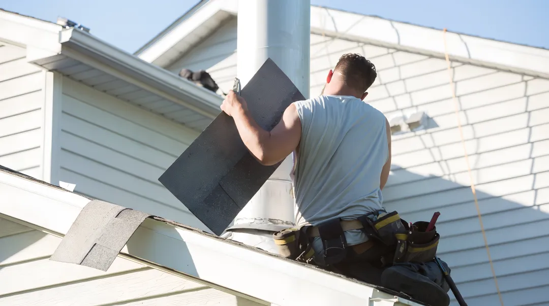 Fortress Roofing Systems technician inspecting South Florida residential roof shingles