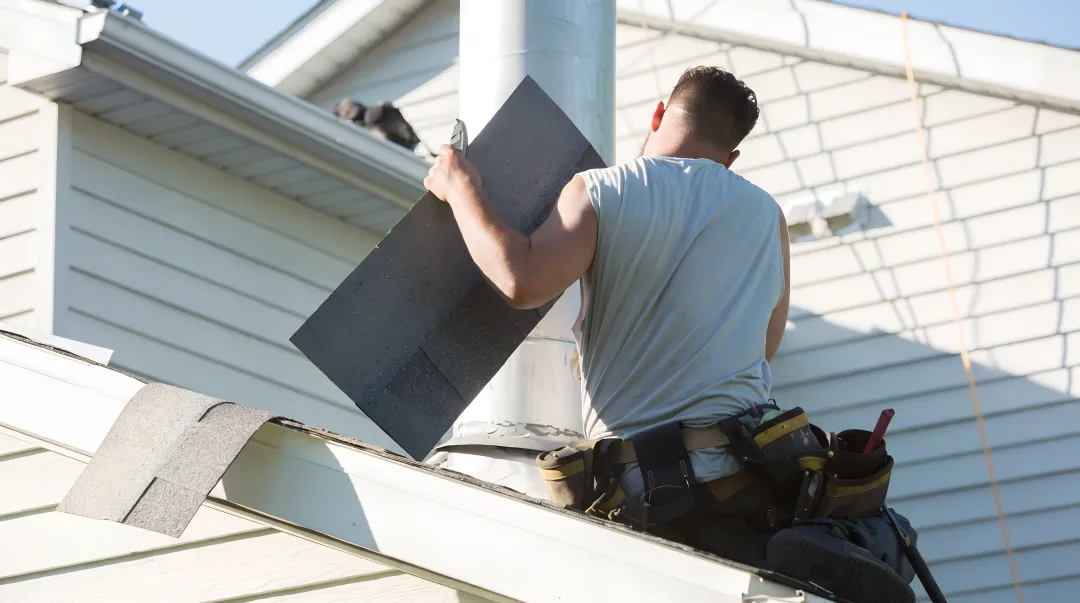 Fortress Roofing Systems technician inspecting storm damaged residential roof
