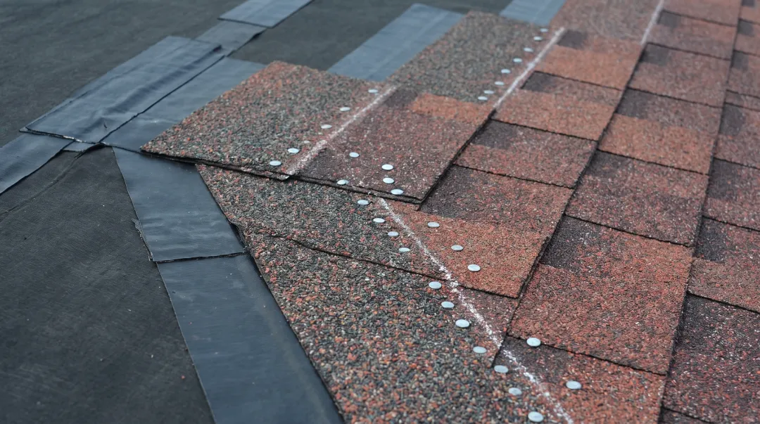 Impact-resistant hurricane shingles installation showing enhanced fastening methods and underlayment system