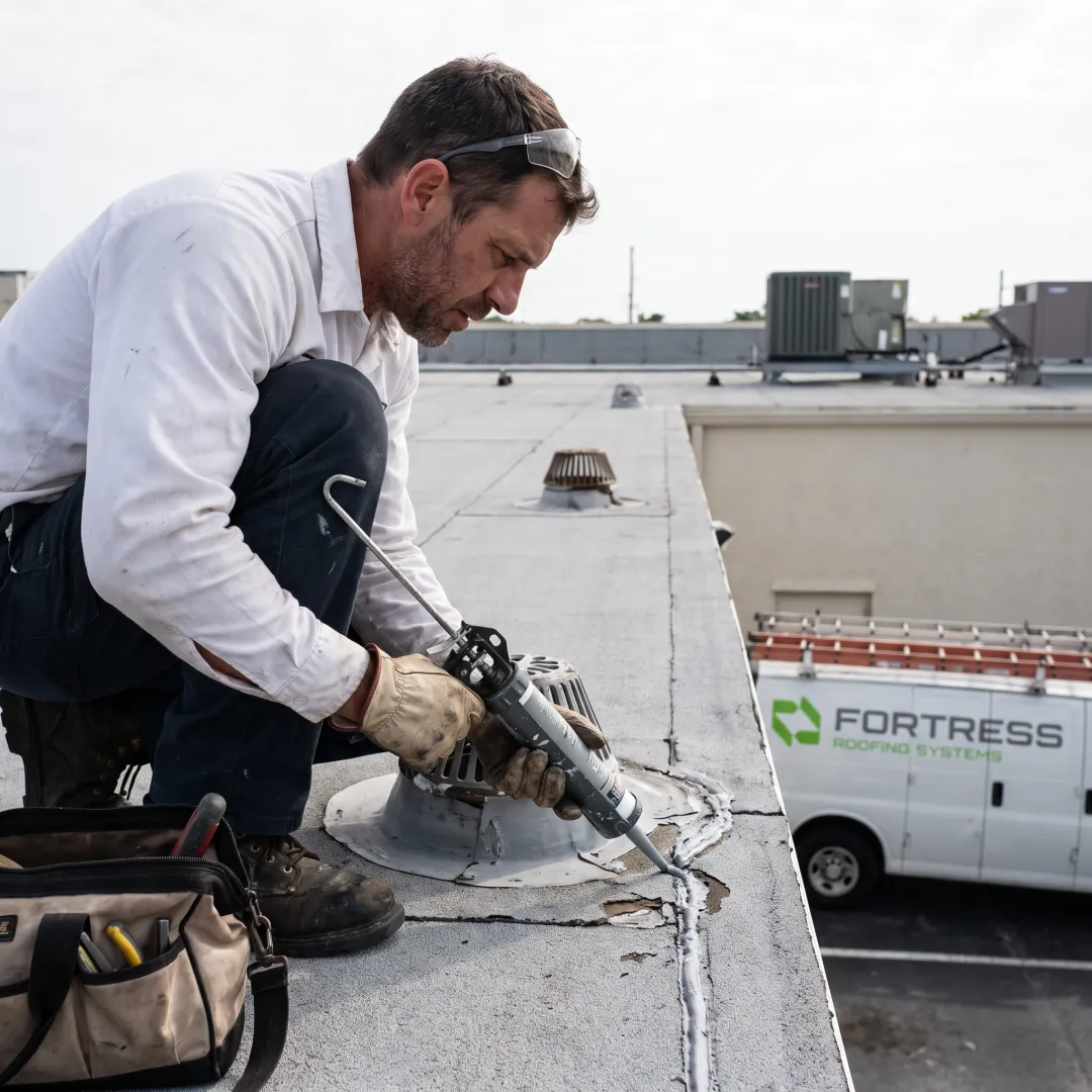 Roofer repairing a flat roof seam
