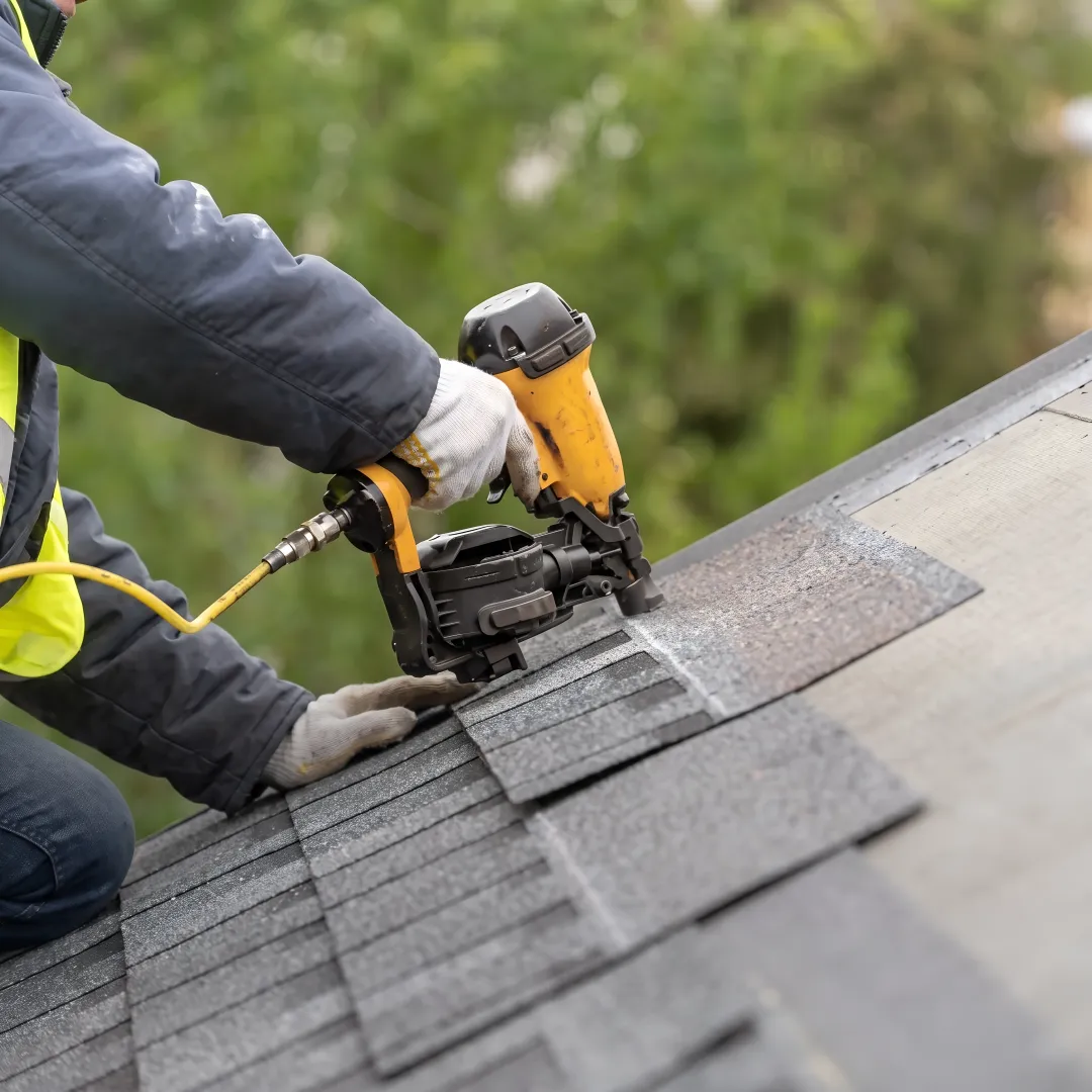 Installer fitting shingles on a Florida roof