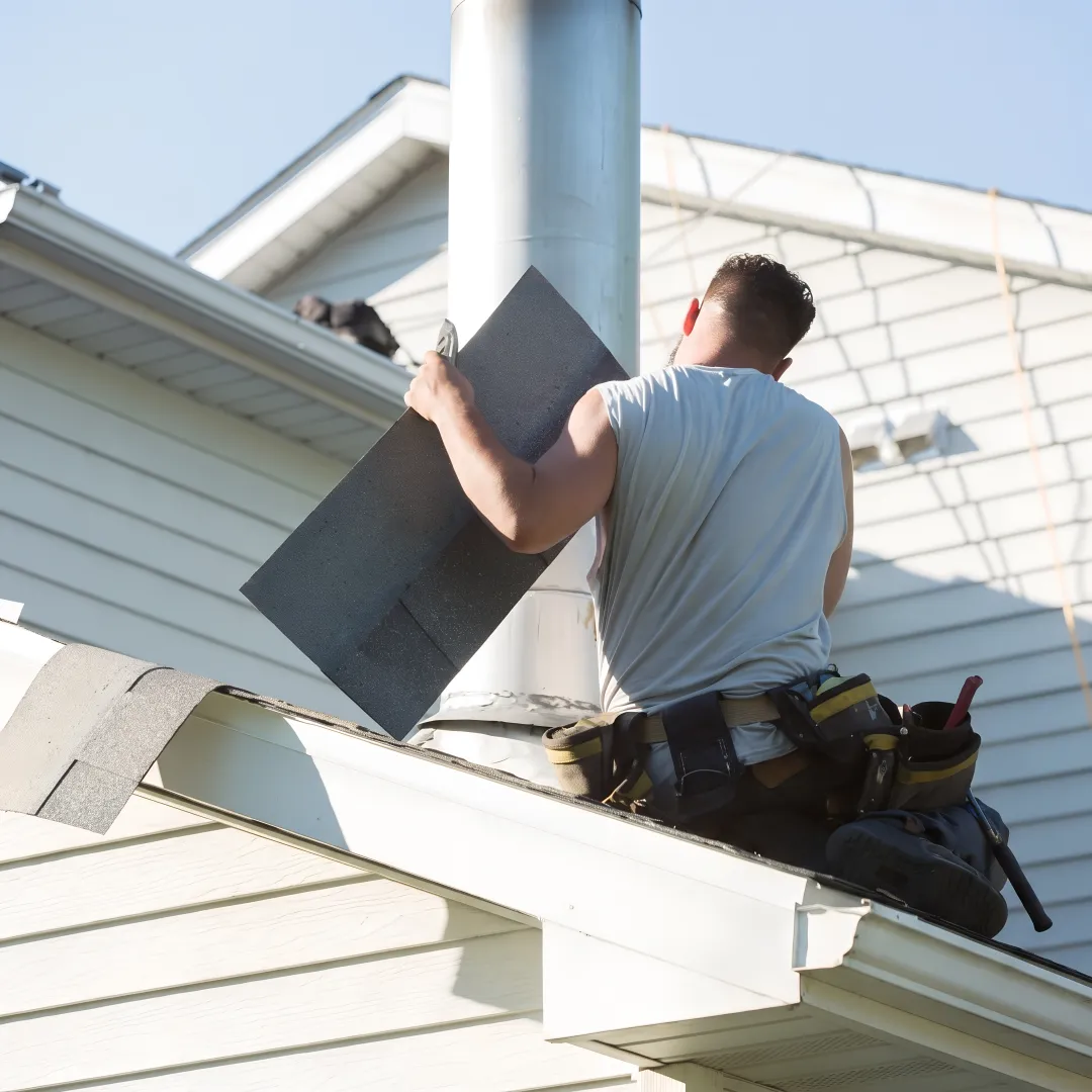 Roofing technician repairing roof flashing
